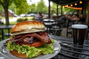 A burger with bacon and lettuce photo