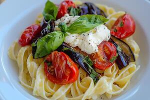 A white plate with pasta and vegetables photo