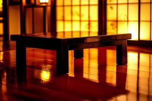 A table with a lamp on it sitting on a hardwood floor photo