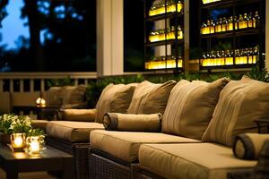 A patio with a couch and candles lit up photo