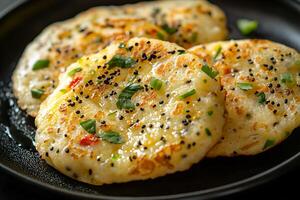 Delicious Potato Pancakes with Herbs and Spices. A close-up image of crispy, golden-brown potato pancakes, garnished with fresh herbs and black sesame seeds. photo