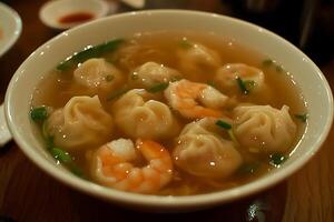 Delicious Shrimp and Dumpling Soup in a White Bowl. A close-up shot of a flavorful Asian soup featuring delicate dumplings and succulent shrimp. photo