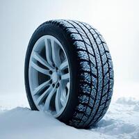 Winter Tire on Snowy Surface with Frosty Background for Auto Use photo