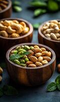 Colorful variety of nuts in wooden bowls. Assorted nuts in wooden bowls are garnished with fresh mint leaves, creating a vibrant and inviting display. photo