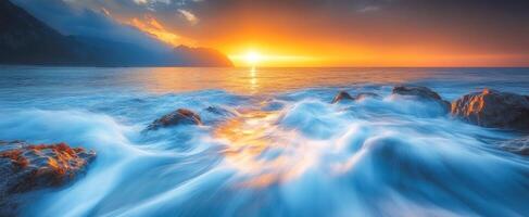 Sunset waves on rocky shore. Sunset envelops the coastline as waves crash against rocks, creating a serene atmosphere on the water's surface. photo