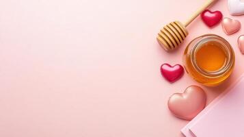 Heart-shaped candies and a jar of honey arranged on a peach-toned background with a blush notebook, creating a sweet and romantic flatlay perfect for any occasion photo