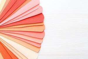 Color swatches arranged on a creative board showcasing a coral palette with deep reds, light green, neutrals, and peach tones for design inspiration photo