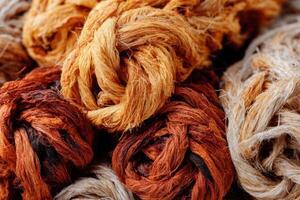 Natural fibers in various shades of brown and beige intertwined in a beautiful display showcasing texture and color for textile design inspiration concept photo