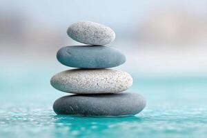 Stacked stones create a tranquil balance above clear water in a serene setting photo