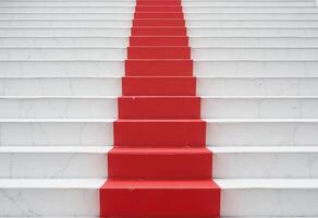 White and red steps lead upward. Red step stands out as next step. photo