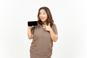 A woman holding a cell phone and pointing at it photo