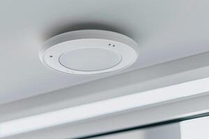 Modern ceiling smoke detector for home safety and security photo