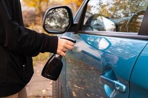Car disinfection service and cleans the inner handle of the car door. Safety and prevention of infection with the Covid-19 virus, infection with microbes or bacteria, wiping clean surfaces photo
