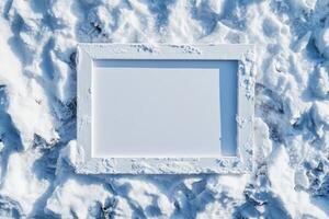 A blank white frame resting on a snowy surface, suggesting potential for creativity. photo