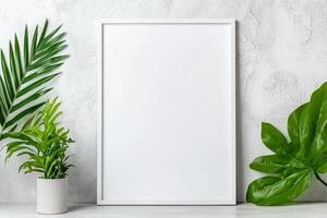 A blank frame surrounded by lush green plants against a textured wall, perfect for decoration. photo