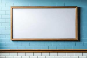 A blank framed whiteboard on a blue tiled wall, ideal for notes or presentations. photo