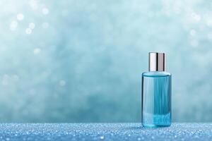 A blue glass bottle on a sparkling background, suggesting a cosmetic or fragrance product. photo