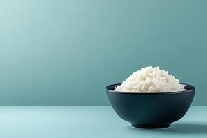 A bowl of fluffy white rice against a minimalist background. photo