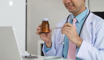 Medication Management and Patient Education. A healthcare provider explains medication using a bottle during a virtual consultation. photo