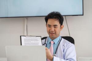 Telemedicine and Patient Consultation. A healthcare professional engaging in a virtual consultation while showing notes on a laptop. photo