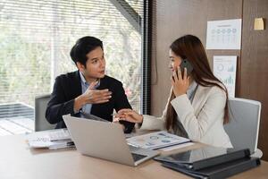Client Consultation and Professional Interaction. A man explaining business ideas to a woman on a phone call during a collaborative meeting. photo