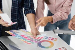 Detail Orientation and Team Dynamics. Colleagues analyzing color charts together. photo