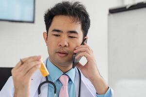 Telemedicine and Patient Engagement. A healthcare professional consulting via phone while analyzing prescription medications. photo