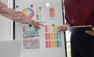 Color Selection and Collaboration. A creative team discussing color palettes for a design project. photo