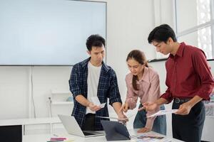 Creative Collaboration and Strategy. Three designers engaged in a lively discussion about color schemes and branding concepts. photo