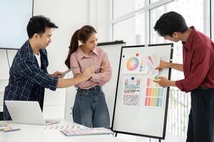 Design Presentation and Feedback. Professionals review and discuss design concepts utilizing colorful visual aids. photo