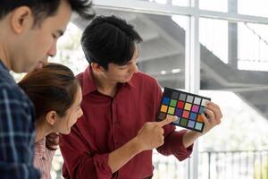Color Analysis and Team Presentation. A designer presents color options to teammates for a project. photo