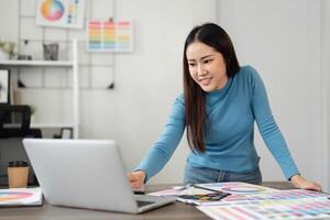 Inspiration and Digital Planning. A designer collaborates on vibrant color selections while engaging with digital content. photo