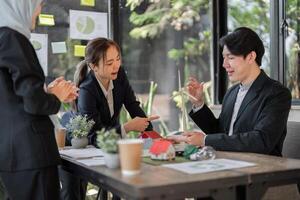 Sustainability and Business Ethics. A team discussing sustainable project proposals, showcasing collaboration and innovation in a modern workspace. photo