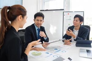 Team Collaboration and Business Strategy. A group discussing data-driven decisions in a modern office. photo