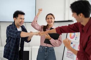 Achievement and Team Unity. Colleagues share an enthusiastic fist bump to commemorate their project success. photo