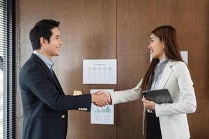 Networking and Agreement. A pleasant handshake signifies successful collaboration between professionals in an office setting. photo