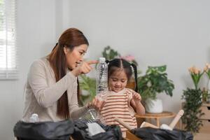 Waste Management and Family Interaction. A mother emphasizes recycling while her daughter enthusiastically learns. photo