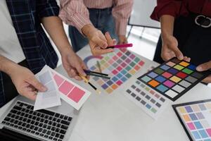 Teamwork and Design Ideation. Creative professionals collaborating on color choices to elevate their project outcomes. photo