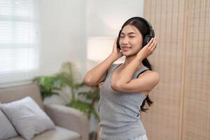 Relaxation and Music. A woman enjoying music with headphones in a peaceful setting. photo