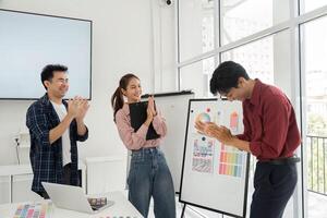 Presenting Ideas and Design Solutions. Team members showcase design concepts and gather feedback from each other in a creative workspace, enhancing collaboration and innovation. photo