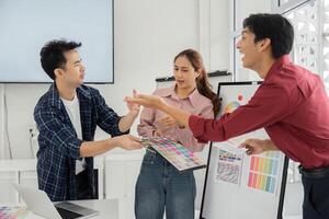 Dynamic Team Interaction on Color Selection. Team members sharing ideas and preferences on color palettes. photo