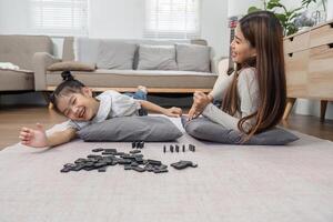 Family Joy and Game Night. A lively scene of a mother and daughter playing together on the floor, emphasizing the importance of quality time. photo