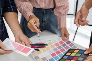 Team Collaboration and Color Selection. A group collaborates on selecting the perfect color palettes for their project. photo