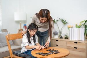 Family Bonding and Playtime. A nurturing mom engaging with her child through a fun and educational game at home. photo