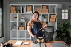 Businesswoman strategizing and organizing her workspace with notes and supplies in a modern office photo