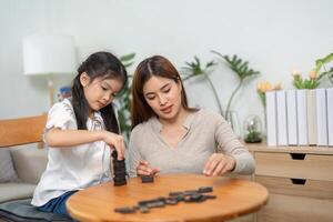 Educational Play and Nurturing Care. A mother guides her child during an engaging game that promotes learning and fun. photo