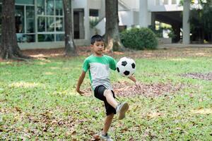 Skill Development and Outdoor Fun. A boy practicing soccer skills with a woman in a park setting. photo