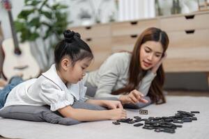 Engagement and Learning. A mother teaches her daughter during a game, promoting interactive play. photo