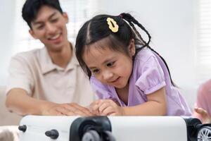 Family Bonding and Playfulness. A joyful father and daughter explore a suitcase together at home. photo