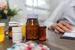 Medication Management and Prescription Review. An array of prescription bottles and medications organized on a table. photo